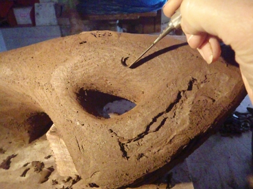 At the point where the form is complete apart from finishing the surface stop building and get ready to hollow -out. The piece should be firm enough to resist a thumb-print. On very large pieces you might start hollowing the top while the lower parts are still too damp; the hollowed clay walls will need to be able to support themselves with-out distorting. Don't let the form get to hard or you wont be able to cut it open.