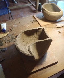 Gently ease it into the shape of the first section of your pot.