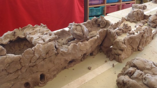 A Military Base with tanks, helicopters and personnel.